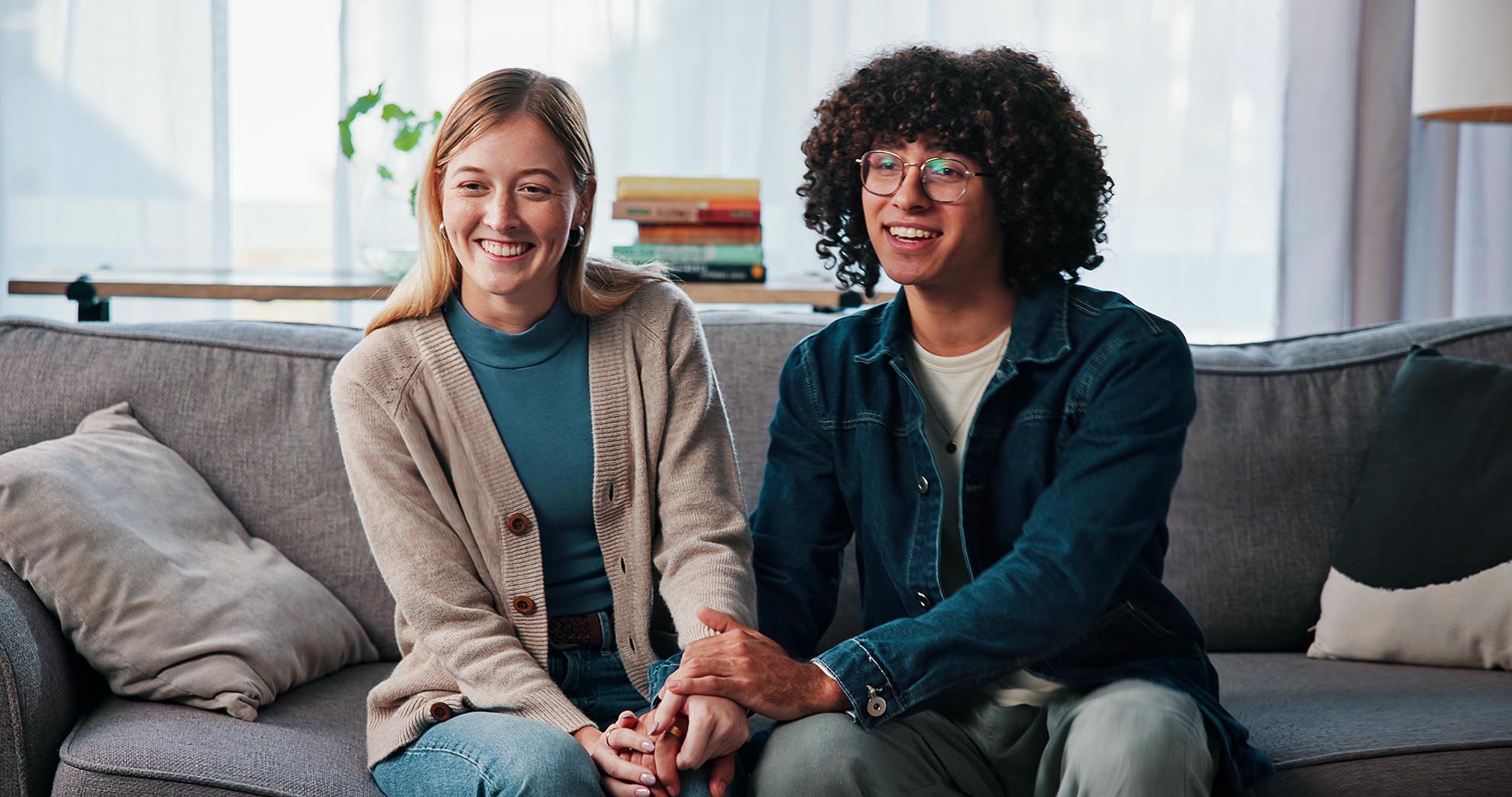 Psychology, happy couple and holding hands in consultation for love, support or reconciliation. Man, woman or counseling for advice in therapy, save marriage or help with interracial people in office